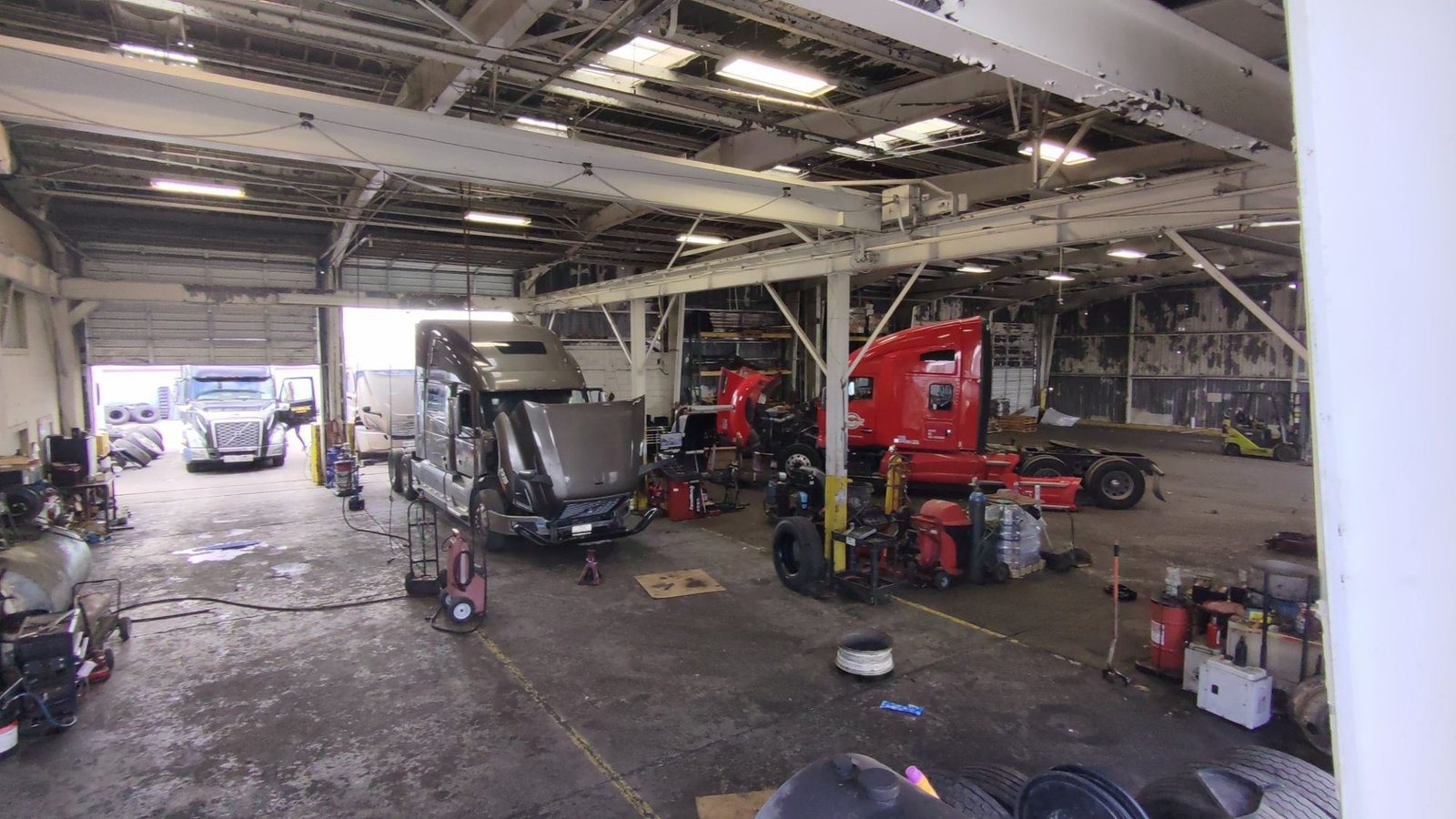 Diesel repair bay with two tractors being serviced at Bawa’s Truck & Trailer Repair, Dallas