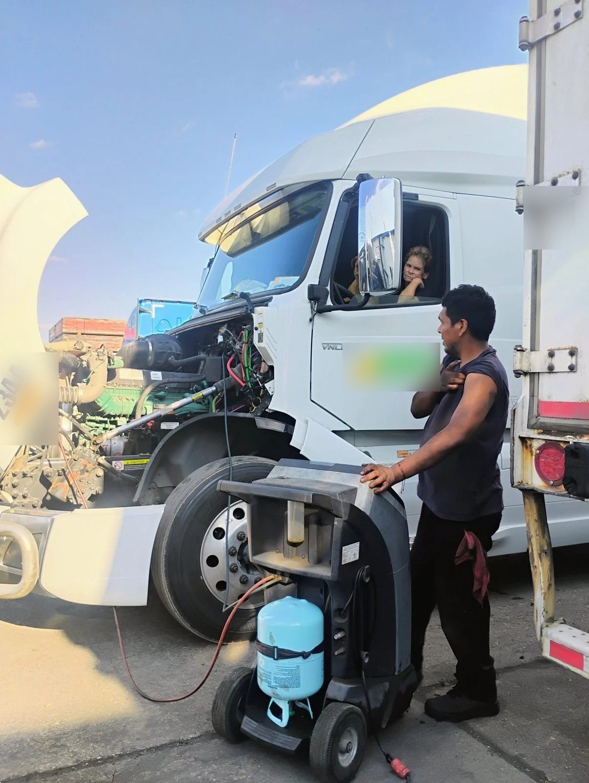 Mechanic and customer during truck air conditioning service at Bawa’s in Dallas